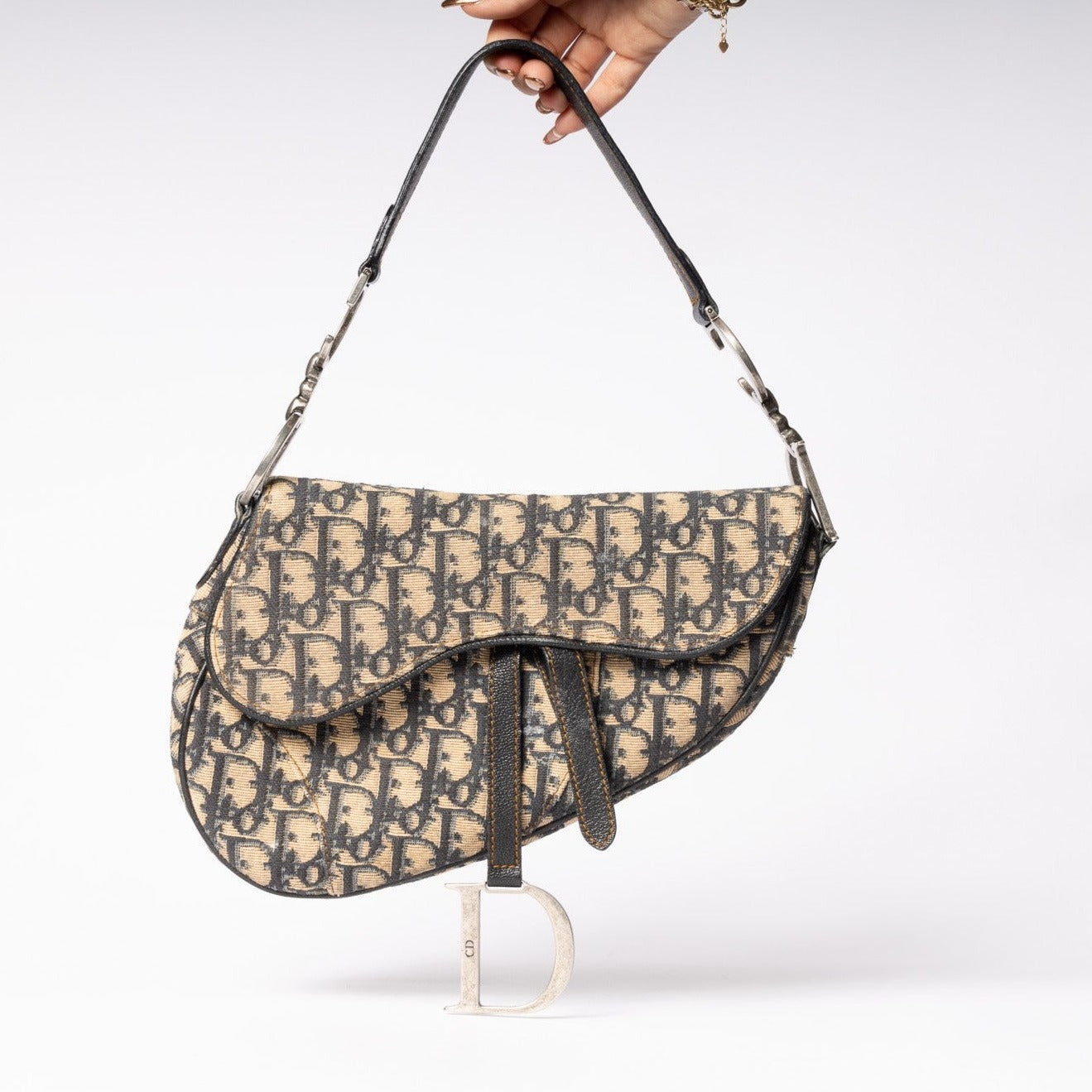 Embrace vintage allure with the iconic Dior Saddle Bag. Elevate your style with this timeless accessory 